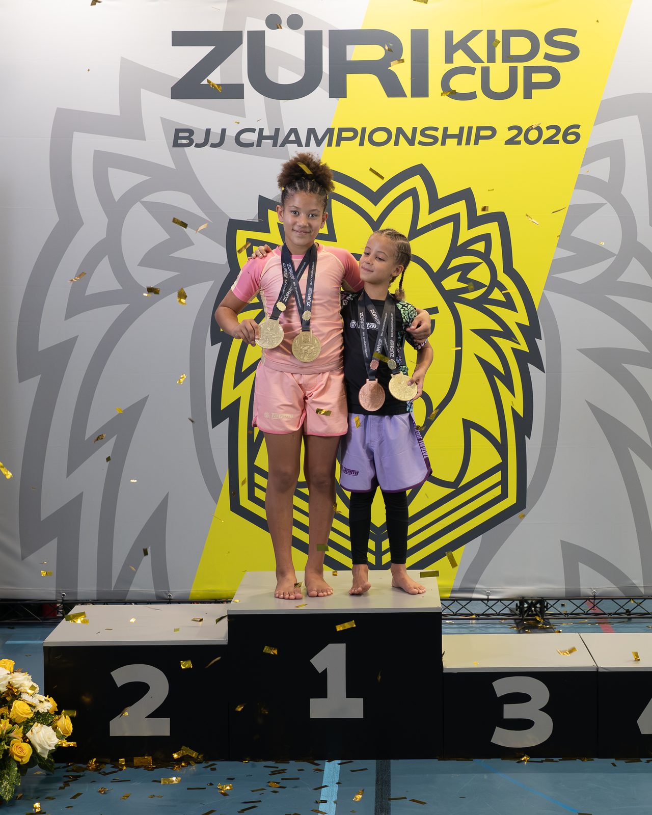 Aylin and her sister on top of the podium at the Züri Kids Cup 2026, with their medals.